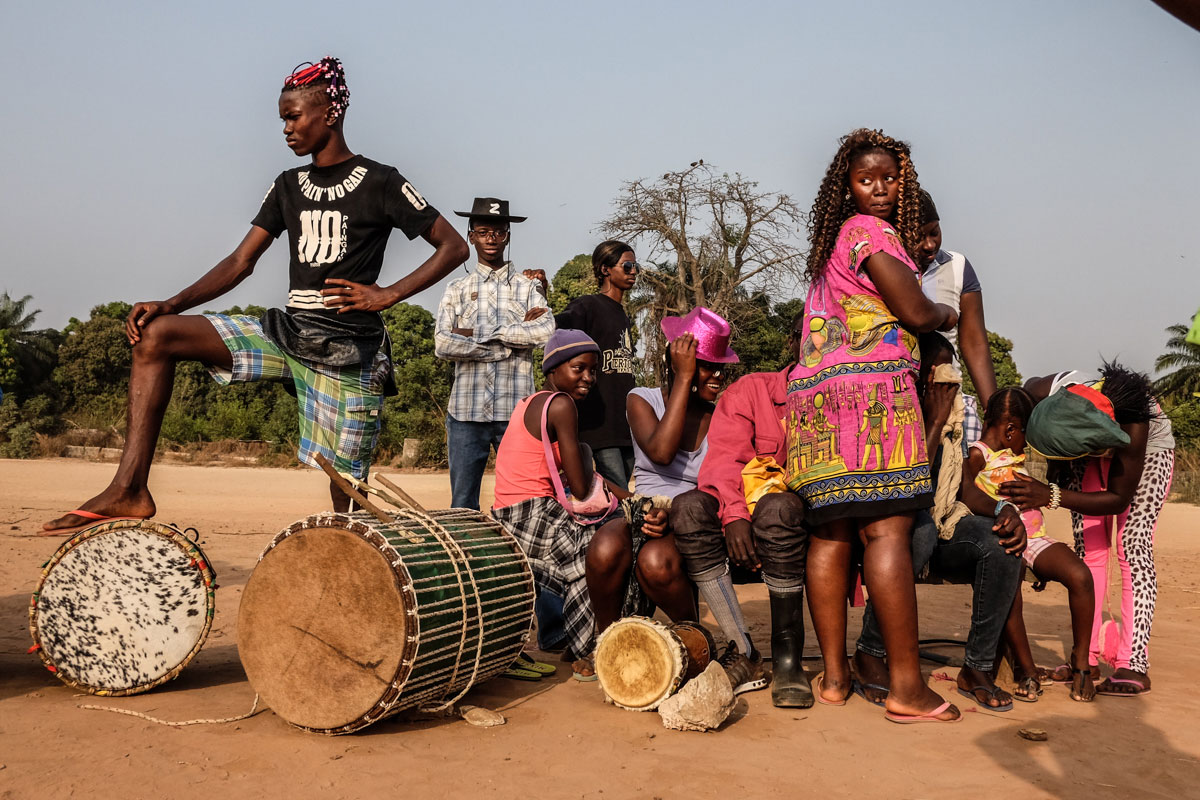 Members of the Iris Carnival group in Bissau wait while their team mates prepare to practise their dance for the big party. [Ricci Shryock/Al Jazeera]