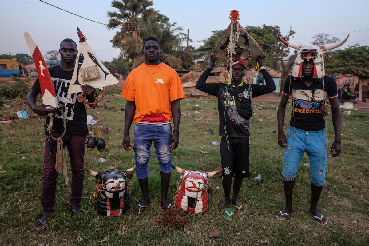 Sene, Aliu, Mamdou and Jonas, from the Bijagos island chain off of Guinea Bissau, pose with their traditional costumes for the Fanado ceremonies on their islands. The ceremony is to celebrate a man's coming of age. [Ricci Shryock/Al Jazeera]