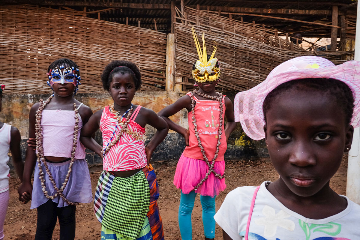 Young girls in Bissau prepare to take part in  the youth parade, part of the former Portuguese colony's carnival celebrations. [Ricci Shryock/Al Jazeera]