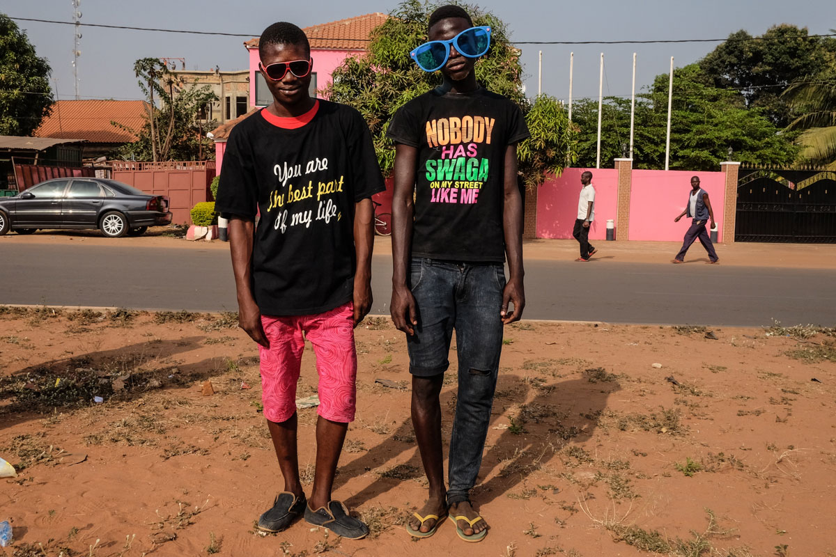 Carnival spectators in Bissau are dressed in funky T-shirts and fun sunglasses. [Ricci Shryock/Al Jazeera]